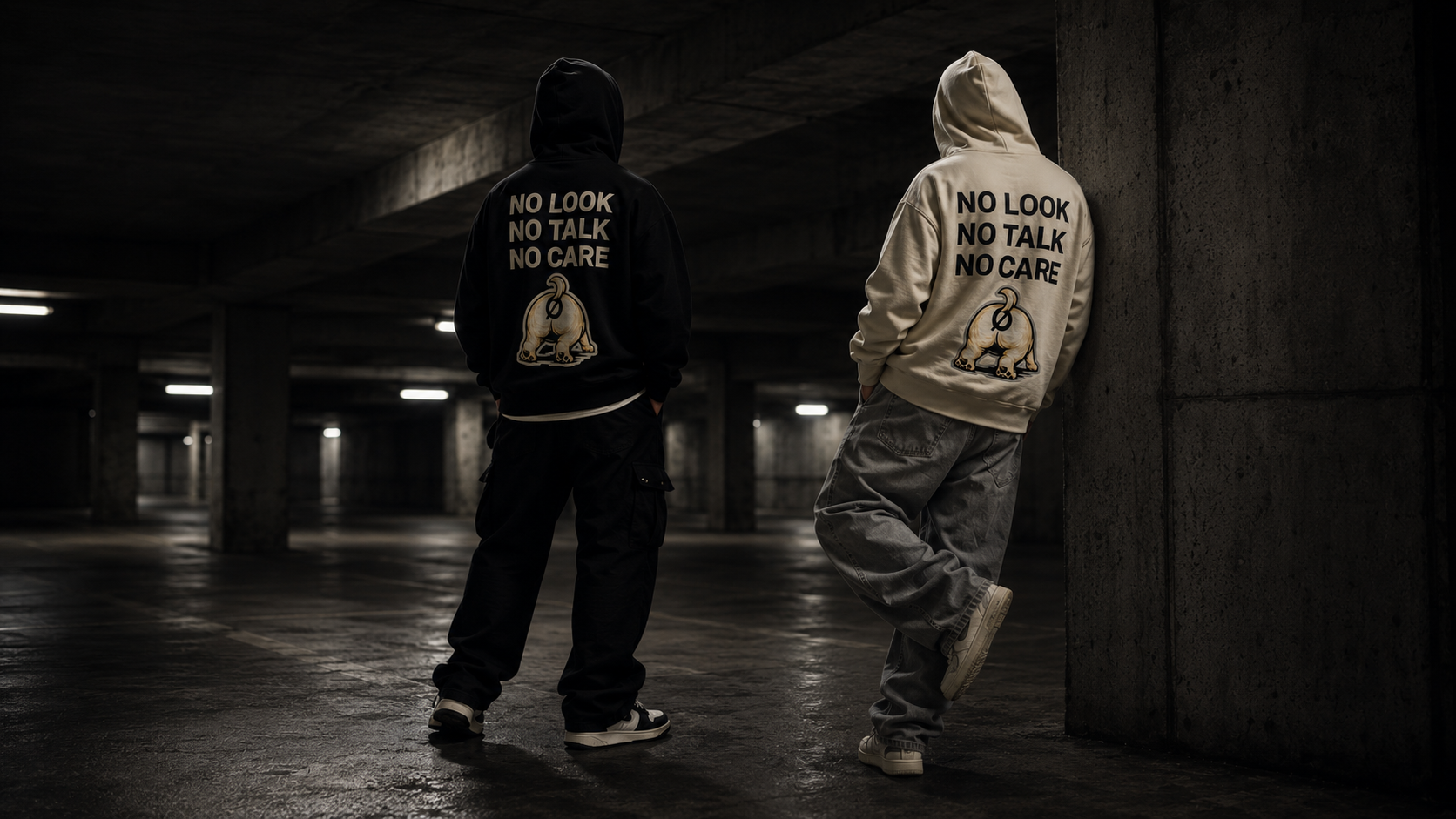 Two models wearing black and bone NØBRK hoodies in a concrete garage